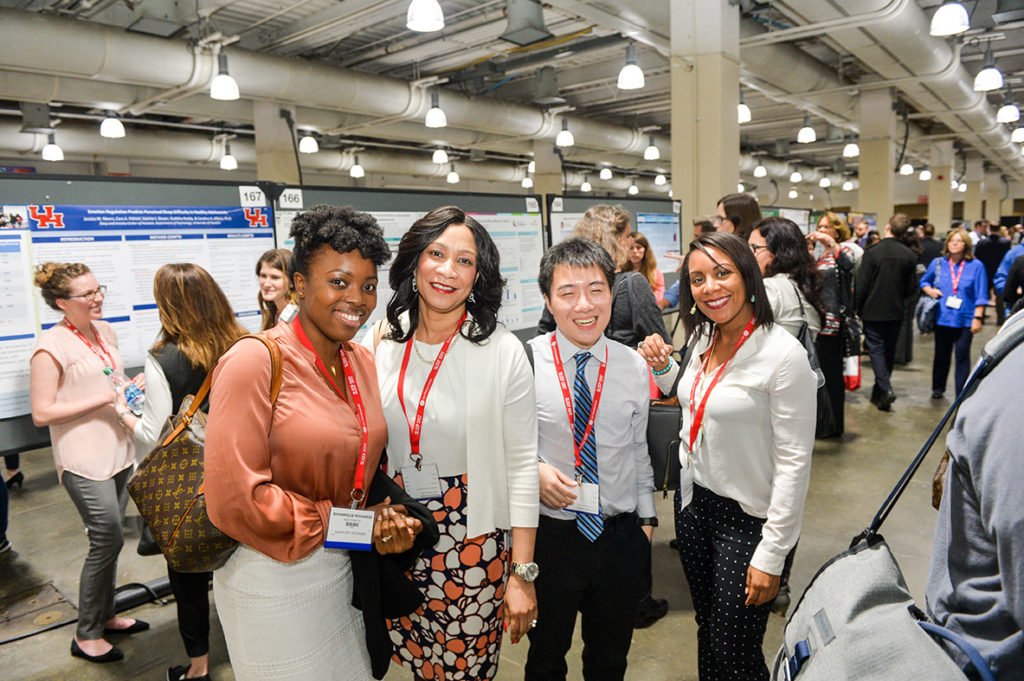 a group of young professionals in a poster exhibit hall